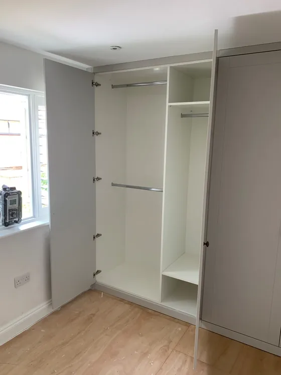 Inside the fitted wardrobe in Colchester showing hanging rails and shelving