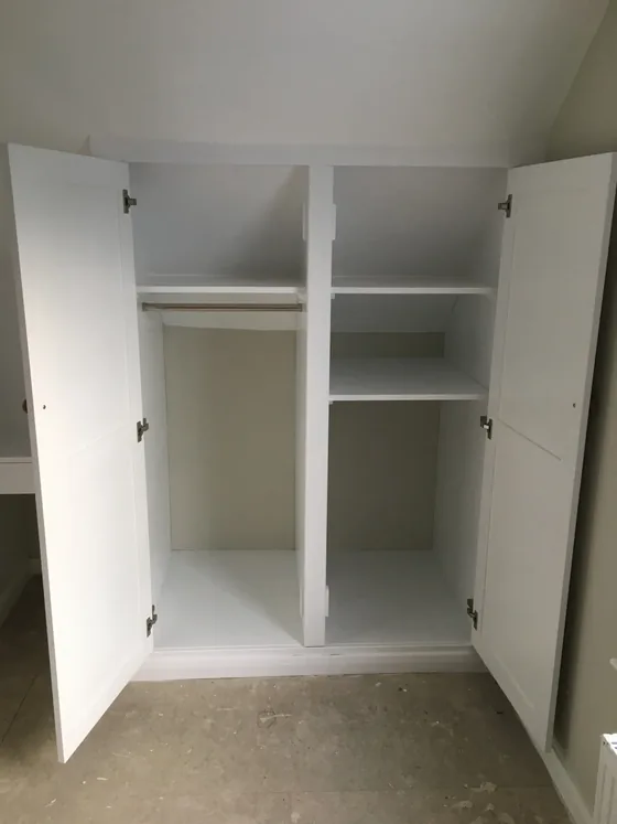 Inside the Dedham fitted wardrobes showing hanging rails and shelving