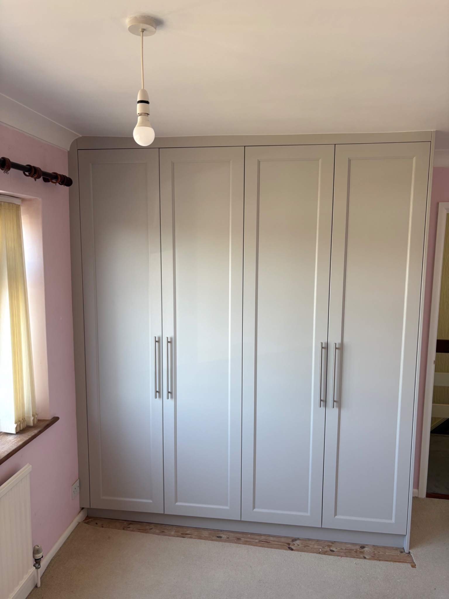 Fitted four door wardrobe with five part shaker doors in Manningtree, sprayed in a soft grey finish