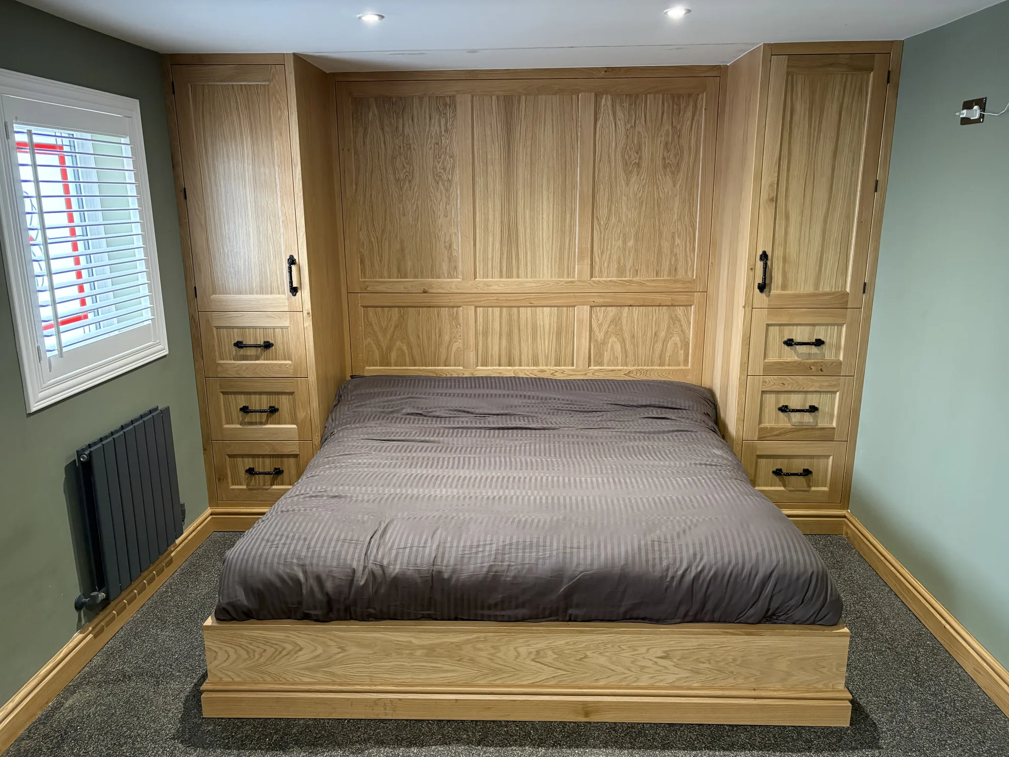 Bespoke fitted dressing room with white drawer banks and pull-out shoe rack