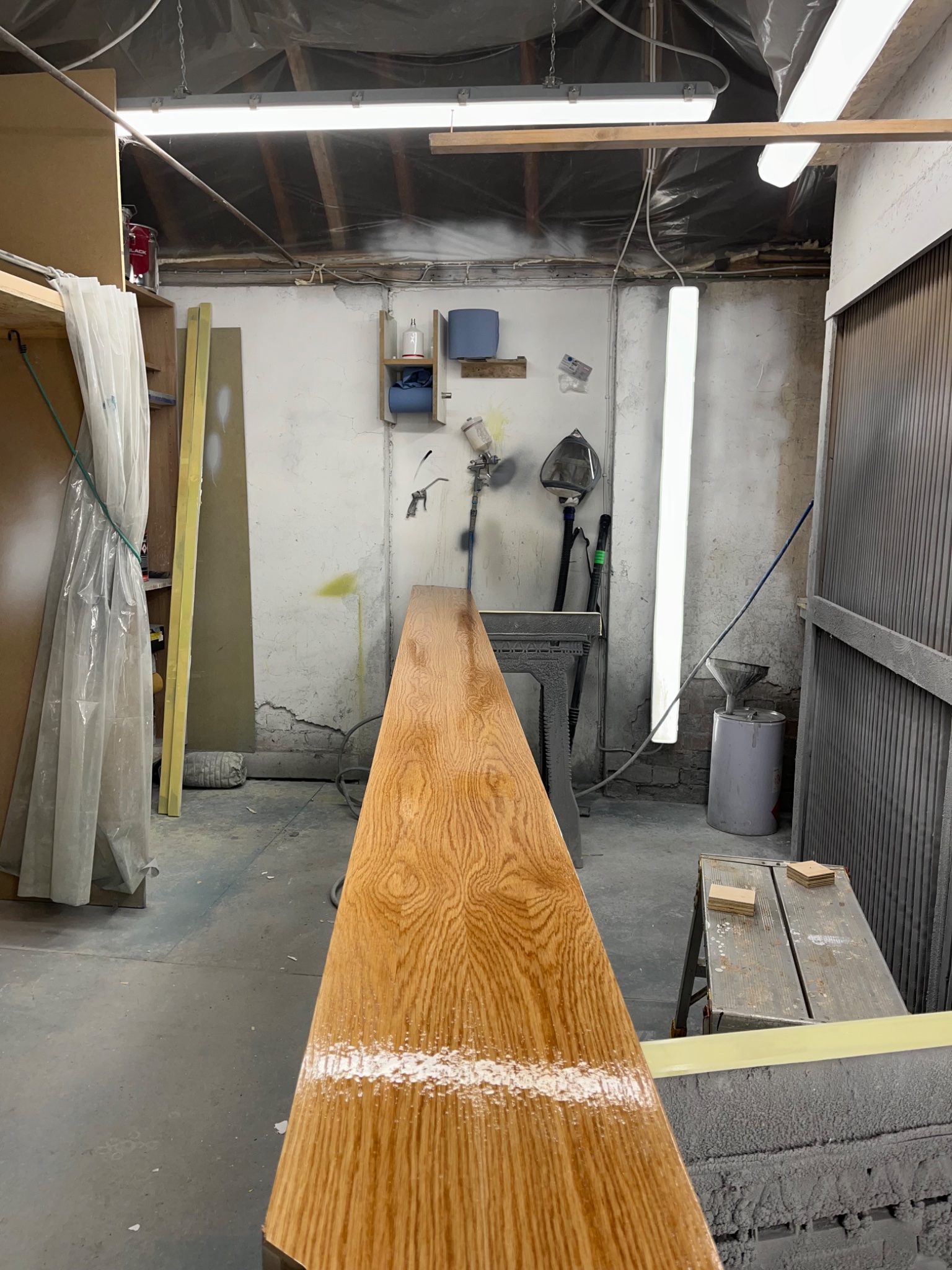 Solid oak handrail sprayed in 2k lacquer in the workshop before installation