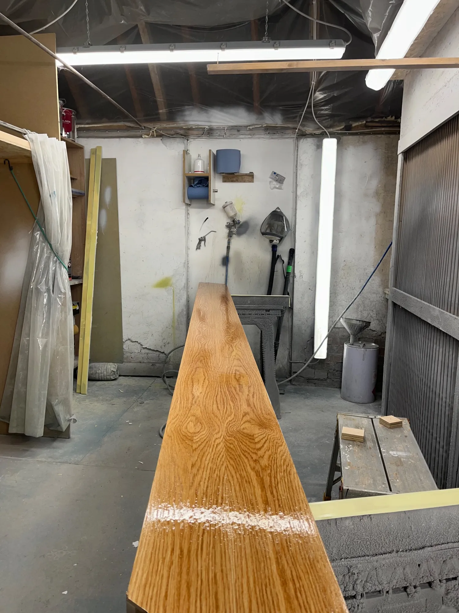 Solid oak handrail sprayed in 2k lacquer in the workshop before installation