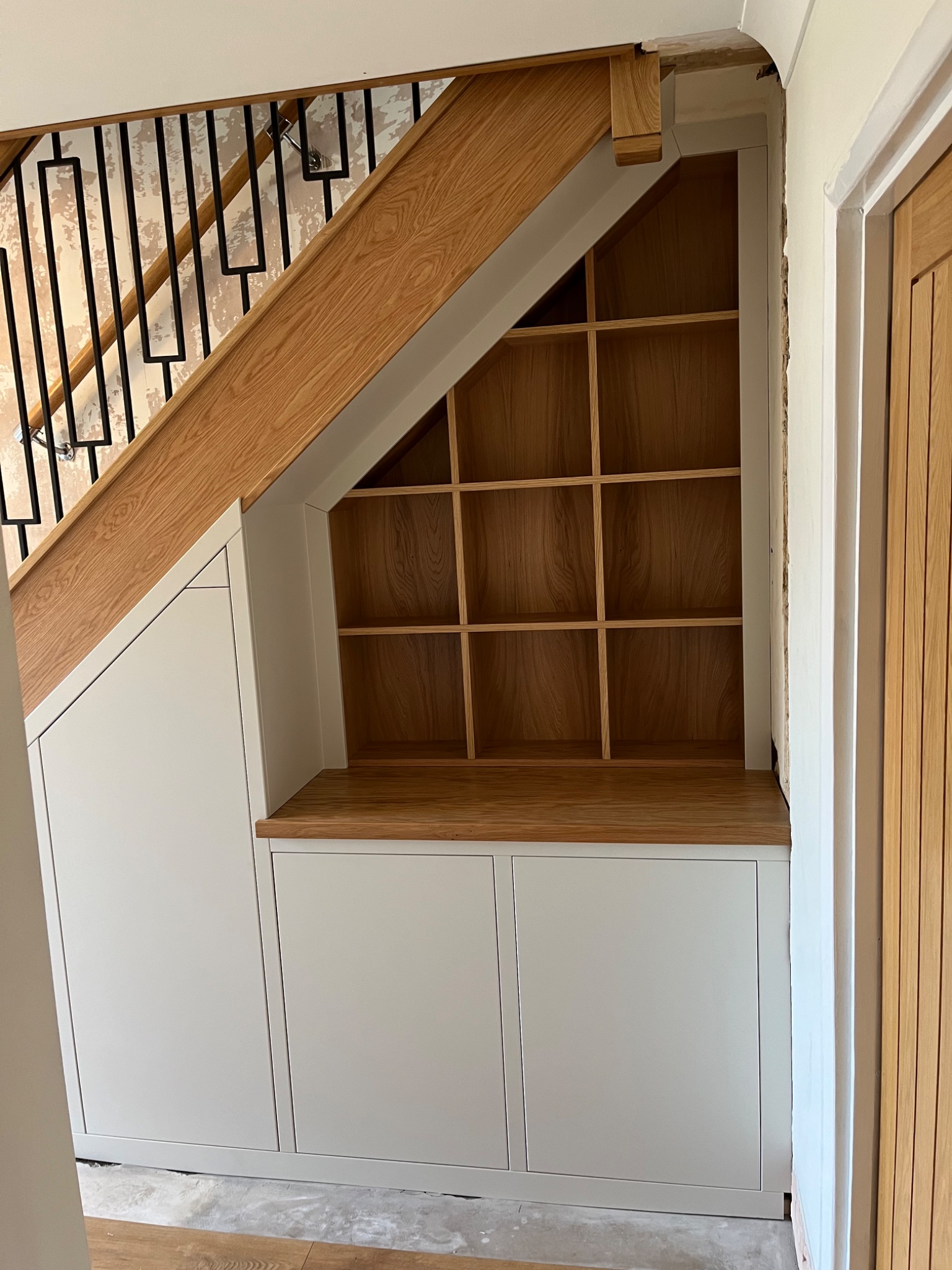Made to measure under stairs cupboards with open oak shelving fitted in Harwich