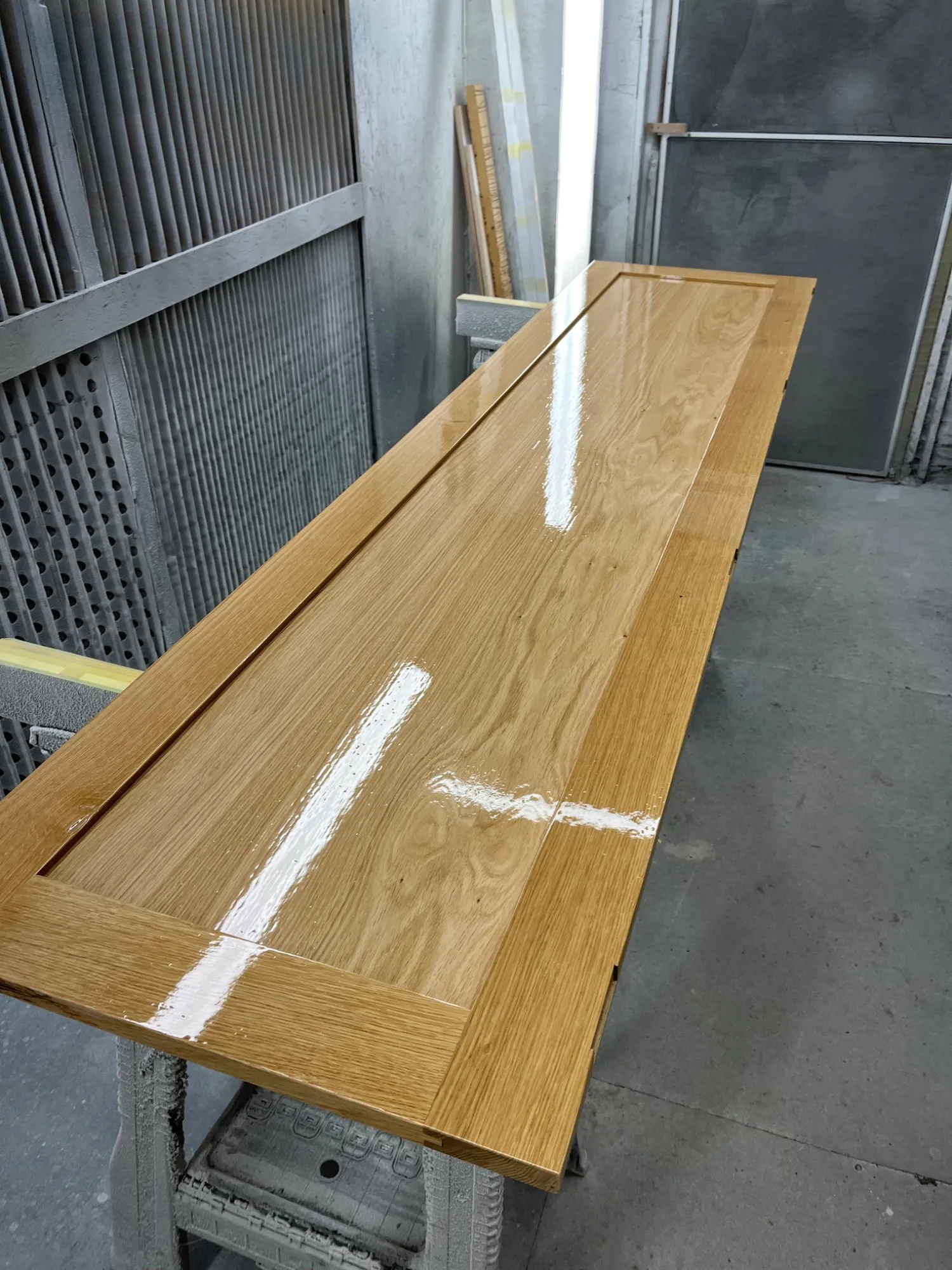 Solid oak shaker style wardrobe door after lacquering in the workshop