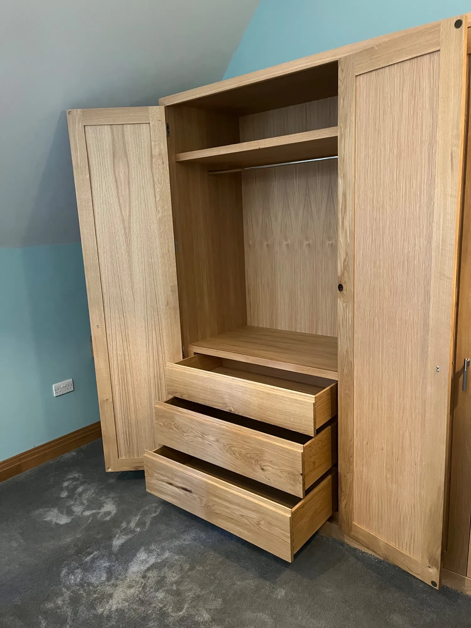Inside the oak wardrobe with drawers, shelving and hanging space, Dedham