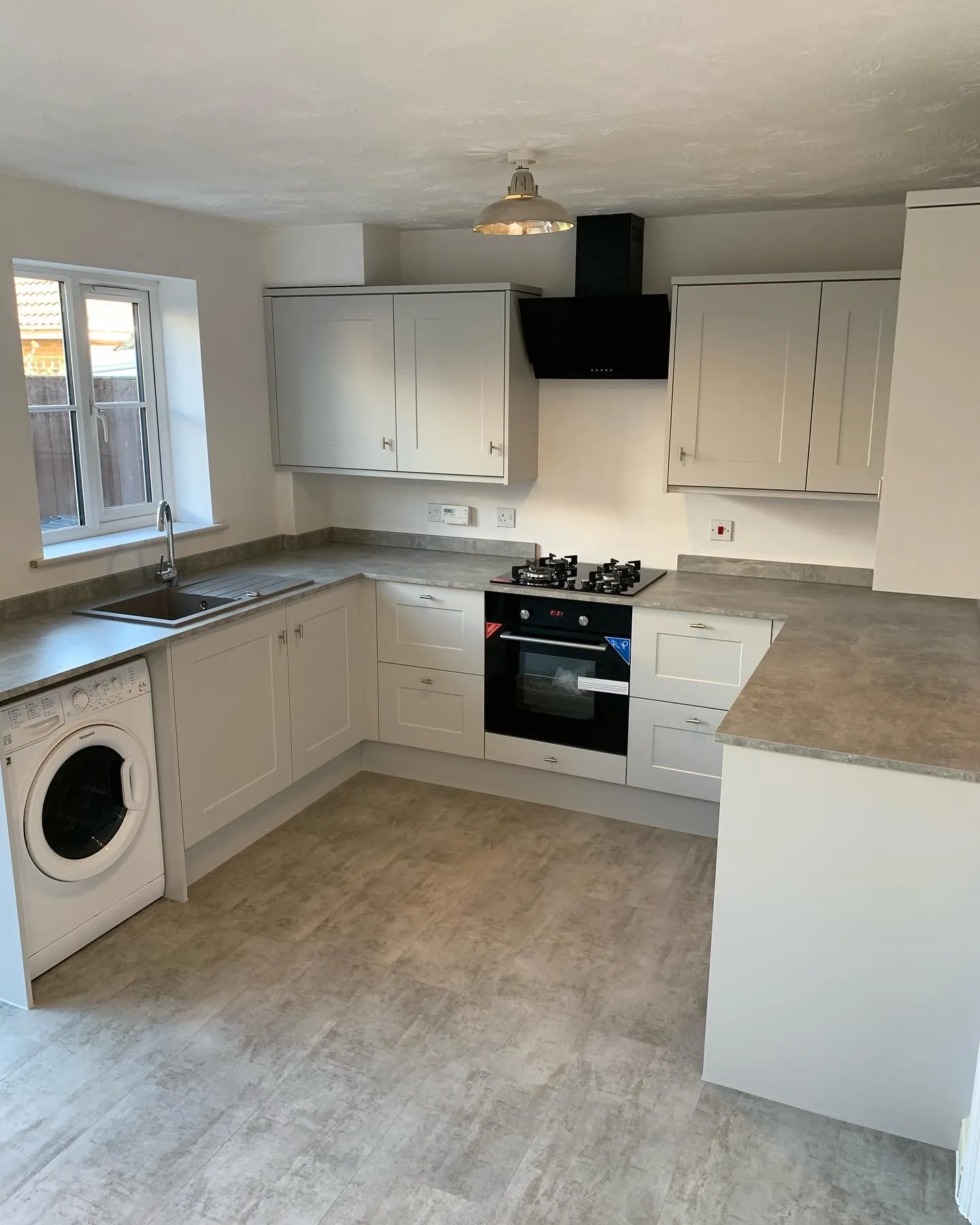 Two-tone bespoke kitchen with handleless upper cabinets